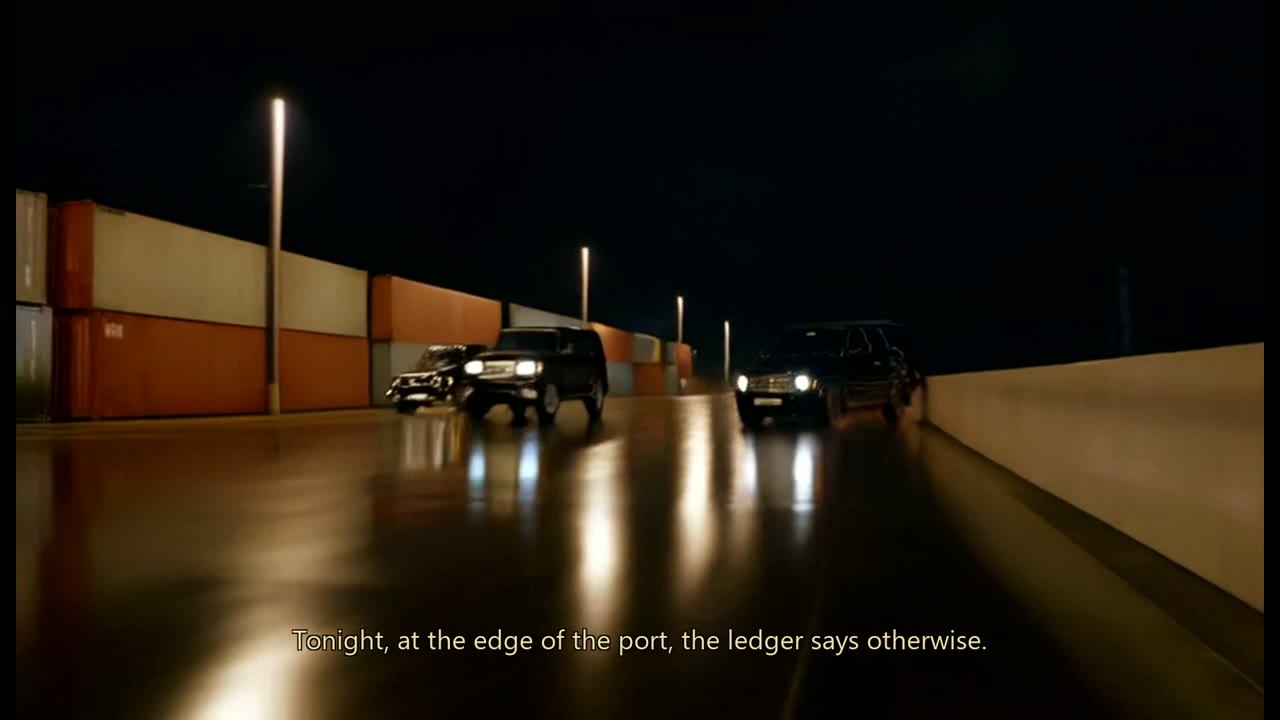 Black SUVs arriving on a wet port road at night